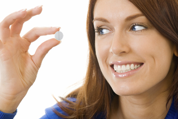 Young happy woman with Omega 3 fish oil capsula, isolated