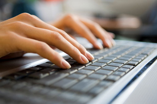 woman-typing-computer-at-ho