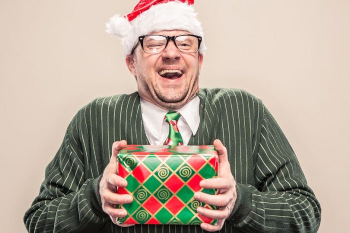 PROD Nerdy Geek Christmas Man Holding Wrapped Holiday Gift