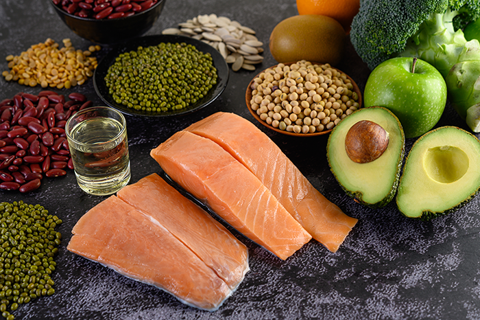 Legumes Broccoli Fruit And Salmon Placed On Black Cement Floor