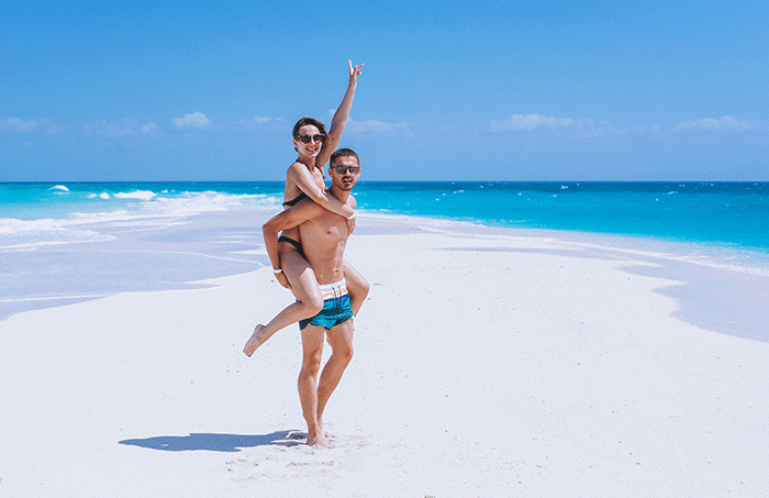 Couple Happy Together On Vacation By The Ocean