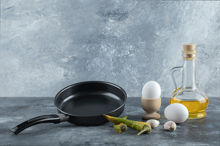 Fresh Organic Eggs With Pepper And Oil Over Grey Background (1)