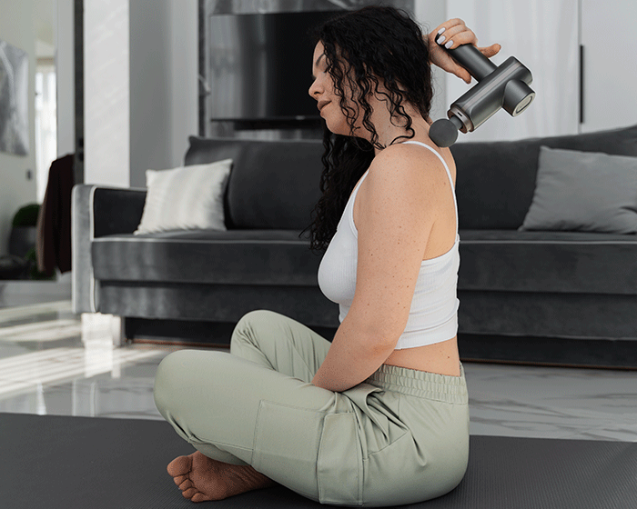 Full Shot Woman Using Massage Gun