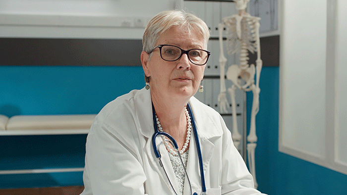 Portrait Of Female Health Specialist Working With Laptop To Plan Patient Appointment In Medical Office General Practitioner Using Medication Notes To Help With Diagnosis And Treatment